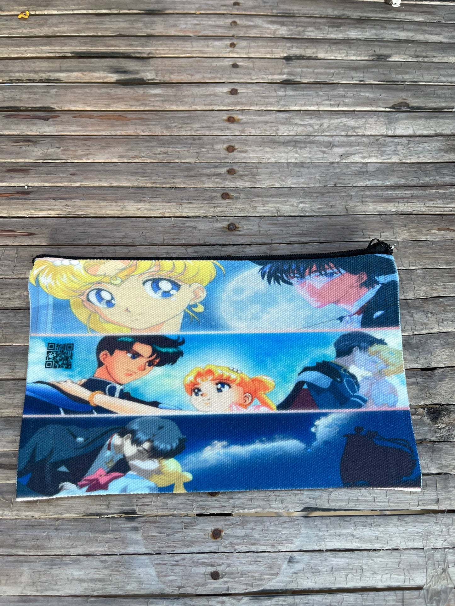 a make up bag with sailor moon  an tuxedo mask on it