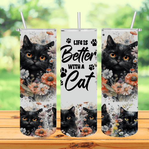 A tumbler with a couple of black cats sitting on top of a wooden table