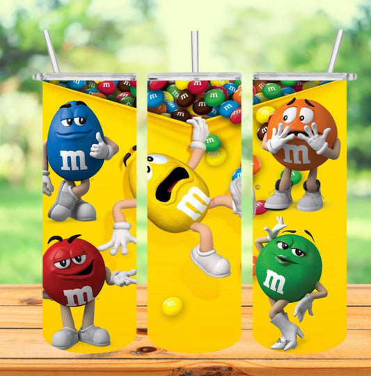 a tumbler of M&M characters sitting on a table