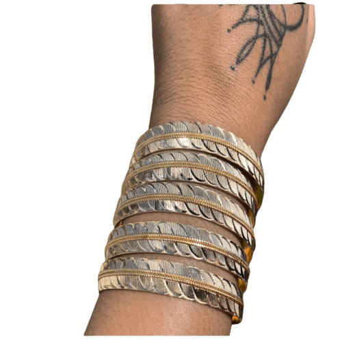 a woman's arm with a bunch of bracelets on it