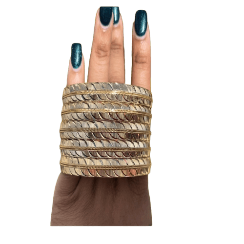 a woman's hand holding a stack of bangles