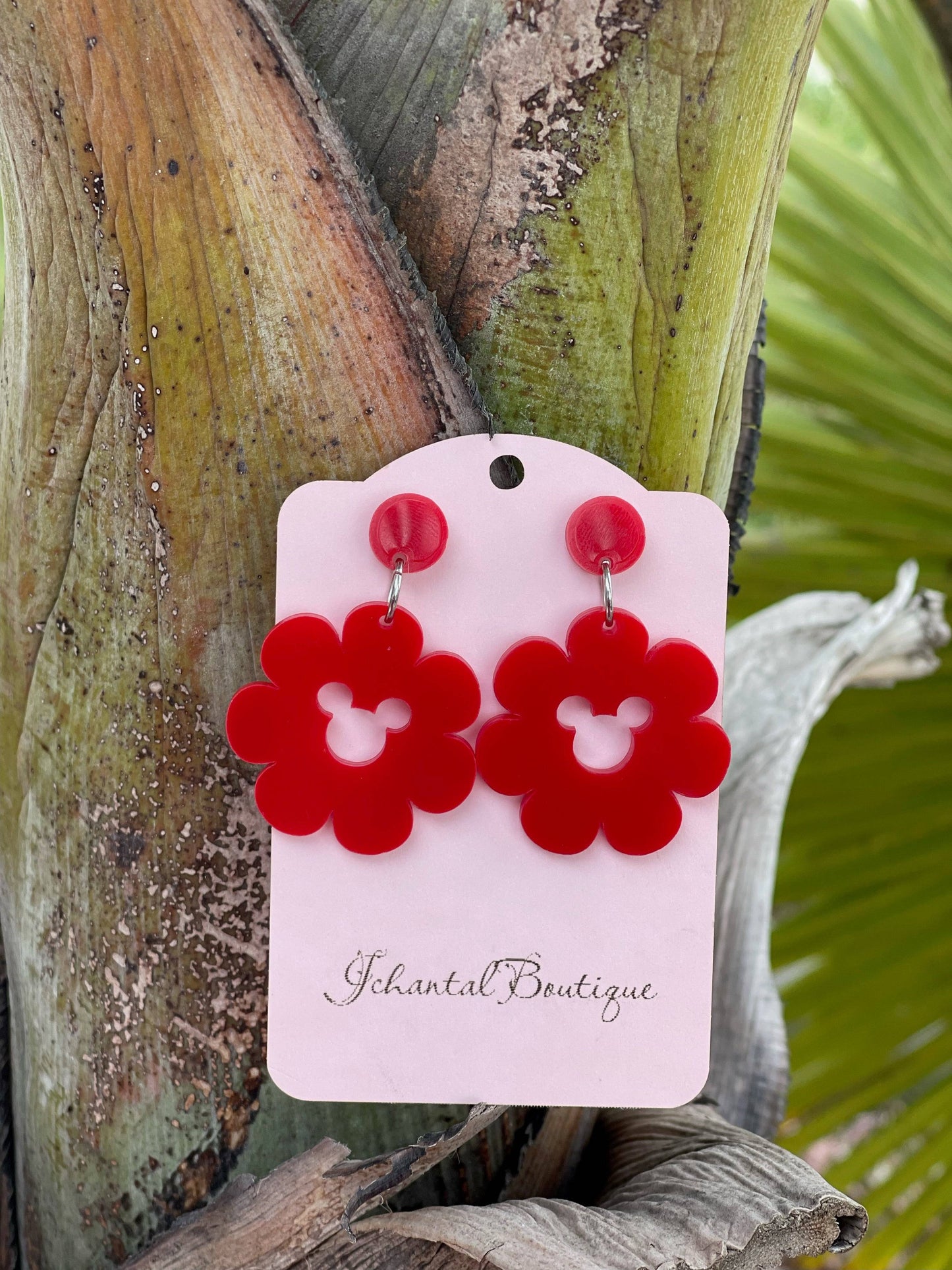 a pair of red acrylic flower shaped earrings