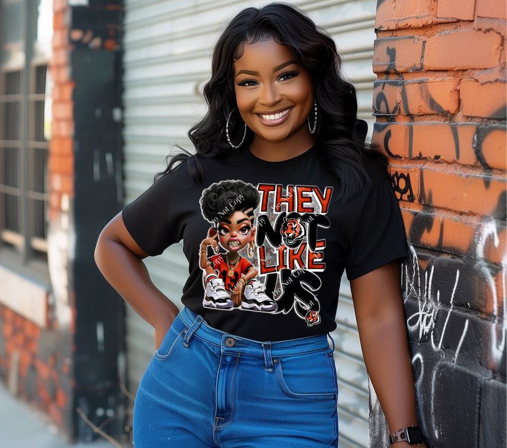 a woman leaning against a brick wall with her hands on her hips wearing a bengals custom t-shirt