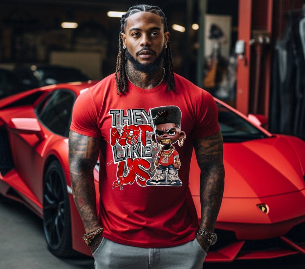 a man standing in front of a red sports car with a custom bucs t-shirt on