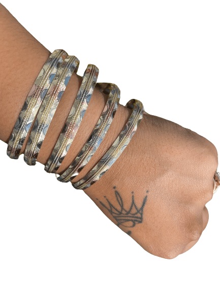 a woman's arm with bangles on it