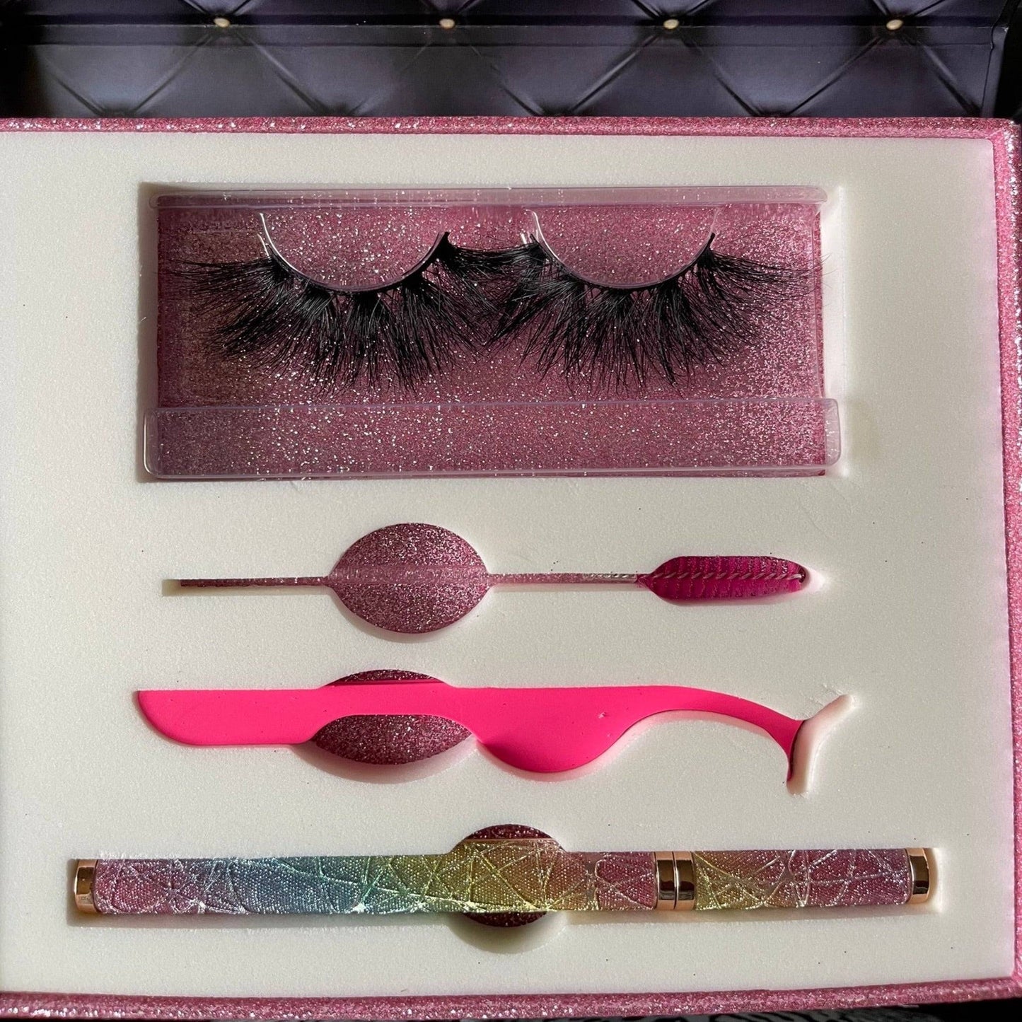 a pink box containing a pair of false eyelashes